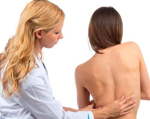Doctor examines the back for lower back pain